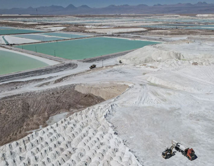 Man with yellow raincoat in a salt flat